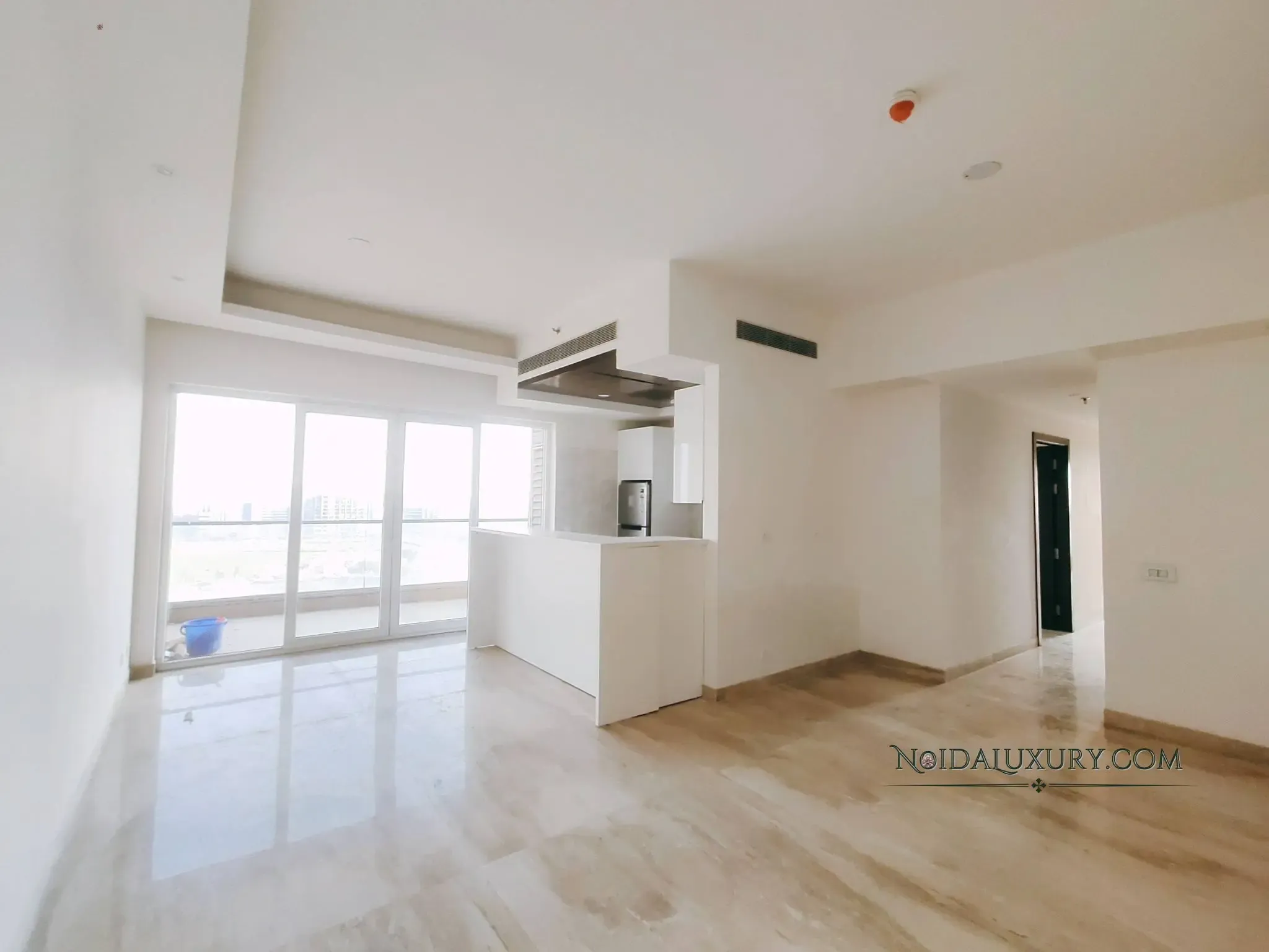 3 BHK flat for rent Supertech Supernova Noida – master bedroom with fitted wardrobes and wood flooring